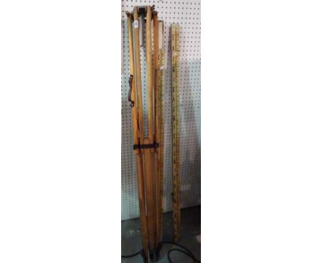 A 20th century pine surveyor's tripod and a 20th century three section metal surveyor's measuring stick, (qty). 