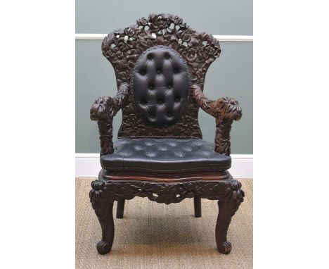 JAPANESE CARVED ARMCHAIR, c. 1900, decorated allover with chrysanthemum carving, button upholstered back and seat, 103cm h