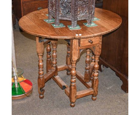 A Light Oak Gate Leg Table, of small proportions with single drawer, 90cm (open) by 75cm by 70cm 