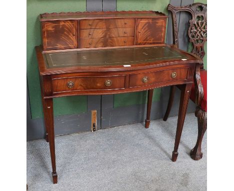 A Reproduction Mahogany Ladies Serpentine Writing Desk, galleried back with arrangement of three drawers and twin cupboards, 