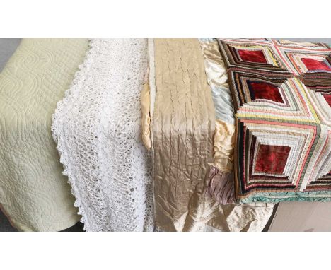 Four 20th Century Quilts and Bed Covers comprising a pink and pale green reversible whole cloth quilt, hand quilted with a ce