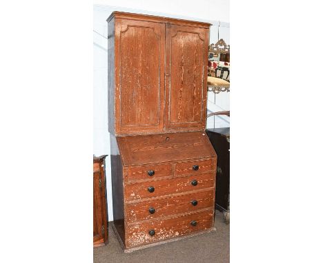 A Victorian Scumbled Pine Bureau Bookcase, moulded cornice above twin cupboatrd doors, shelved interior, the base with fall f