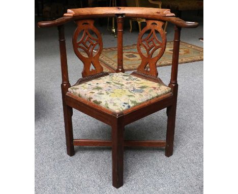 An Anglo-Chinese Rosewood Corner Armchair, mid 18th century, of pegged construction, with pad arms, open fret splats, ring tu