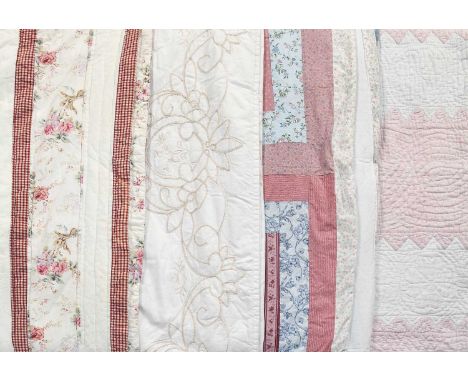Four 20th Century Quilts comprising a pink and white strippy quilt, the pink stripes with zip zag edges with pink and blue st