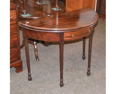 A George III Mahogany Fold Over Demi-Lune Card Table, with later single drawer, raised on on fluted &amp; tapered supports, 9