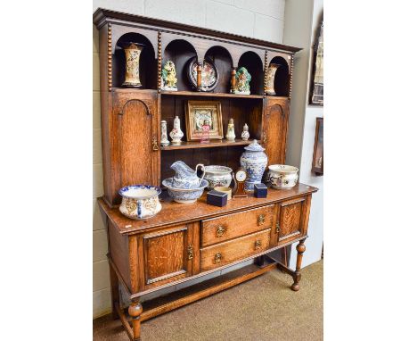 An Oak Dresser and Rack, circa 1900, with bobbin turned mouldings, turned supports and H stretcher, 154cm by 56cm by 199cm