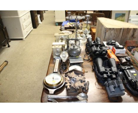 A quantity of various metal ware and clocks to include a Kuno electronic mantel clock, twin branch candelabra, barometers, cu