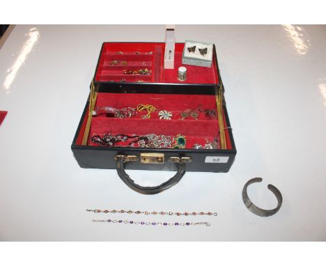 A cantilever jewellery box and contents of jewellery to include dress ring, bracelets, ear-rings etc.