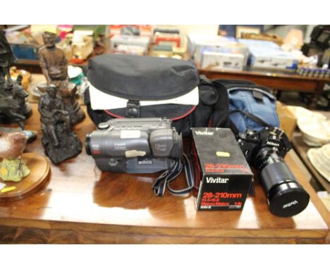 A Canon camcorder with carry bag, and a Nikon EM camera and lens 