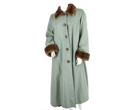 Yves Saint Laurent, a ladies green full-length coat with brown fur trim, featuring front button fastenings, sheared beaver li
