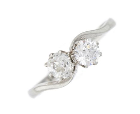 An early 20th century platinum old-cut diamond two-stone crossover ring, with asymmetric shoulders, estimated total diamond w