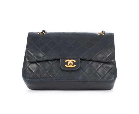 Chanel, a Medium Double Flap handbag, featuring the maker's signature diamond quilted lambskin leather exterior, with gold-to