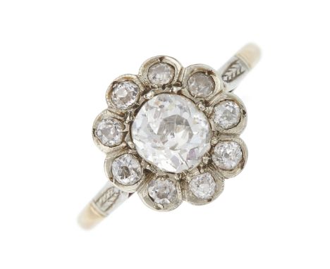 An Edwardian gold old-cut diamond cluster ring, with foliate engraved shoulders, estimated total diamond weight 0.70ct, I-K c
