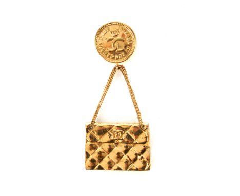 Chanel, a vintage handbag brooch, featuring the maker's iconic diamond quilted Classic Flap handbag, hanging from a pin butto