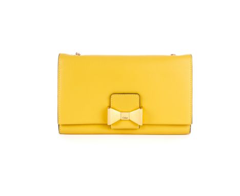 Chloe, a Wallet On Chain Bow handbag, crafted from smooth mustard yellow leather, with gold-tone hardware to include a front 