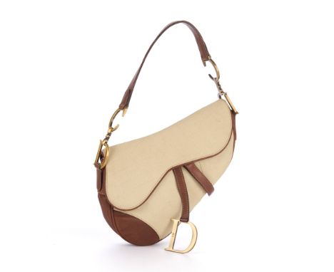 Christian Dior, a Saddle handbag, featuring a cream canvas exterior with smooth brown leather trim, flat shoulder strap with 