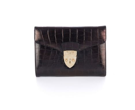 Aspinal of London, a crocodile embossed leather clutch, featuring polished gold-tone hardware, shield lock front fastening an