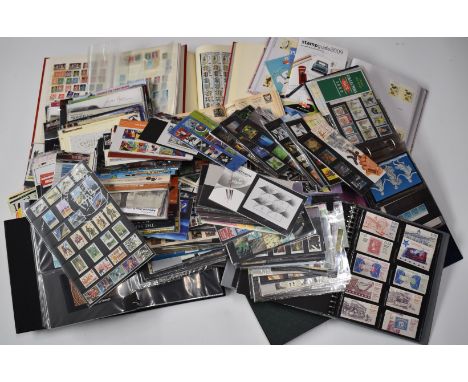 A large accumulation of GB mint postage stamps in albums, presentation packs etc along with first day covers and world stamps