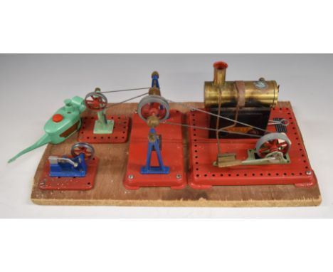 Mamod stationary live steam plant with engine, hammer, press, pulleys and oil can, mounted on wooden board.&nbsp;