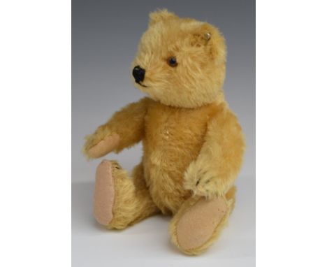 Steiff Teddy bear with blonde mohair, straw filling, disc joints, stitched features and button to ear, 23cm tall.&nbsp;