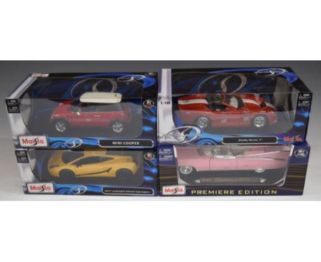 Four Maisto 1:18 scale diecast model cars comprising Mini Cooper, Shelby Series 1, 1959 Cadillac Eldorado Biarritz and 2007 L