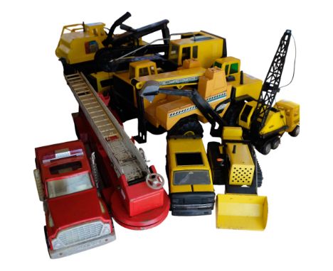 A large collection of mid-century Tonka Toys, including cranes, dump trucks, bulldozers, etc