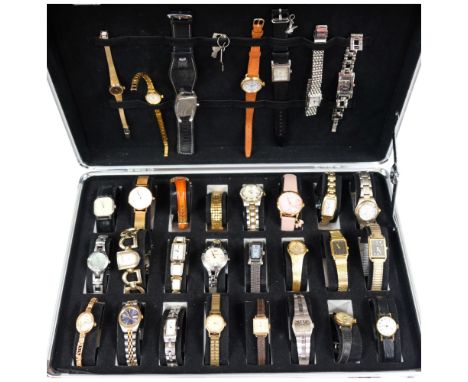 A cased display of various lady's mainly quartz wristwatches, including Fossil, Junghans, Limit, Radley, Sekonda, etc