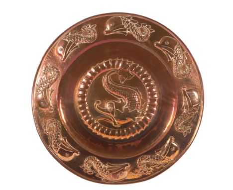 Newlyn School, large Arts and Crafts copper tray with relief embossed dolphin designs, unsigned, diameter 59cmNo splits or re