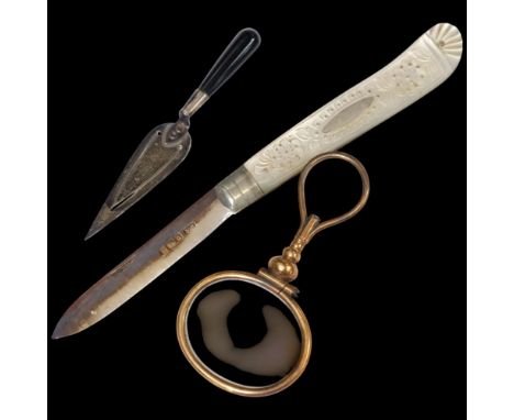 An early 20th century mother-of-pearl and silver-bladed fruit knife, cased, a small silver trowel design bookmark, and a gilt