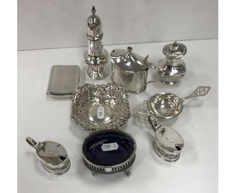 A collection of small silver wares to include a Georgian style baluster pepper, rounded rectangular semi-reeded pepper, pierc