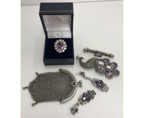 A collection of jewellery to include an amethyst set dress ring, a pair of Art Deco style and amethyst set earrings, a peacoc