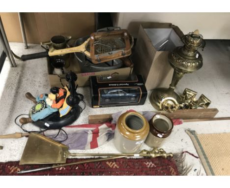 A collection of items to include a brass mounted spark guard a large brass oil lamp with globe and glass funnel, a collection