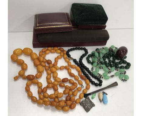 An amber bead necklace 102 g together with a graduated amber bead bracelet 48 g and three further beaded necklaces, a silver 