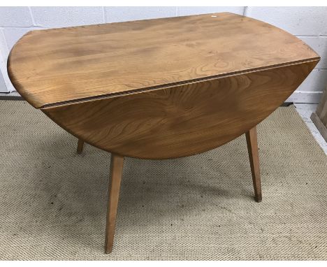 An Ercol elm oval drop leaf dining table on square tapered legs 112 cm x 123.5 cm x 70 cm high together with a set of four el