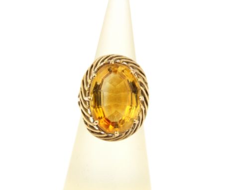 A 9ct yellow gold (tested) ring set with a large oval cut citrine, (M).