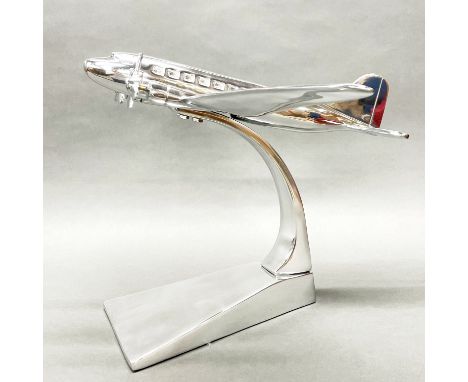 A large polished aluminium desk model of an aeroplane, wing span 60cm.