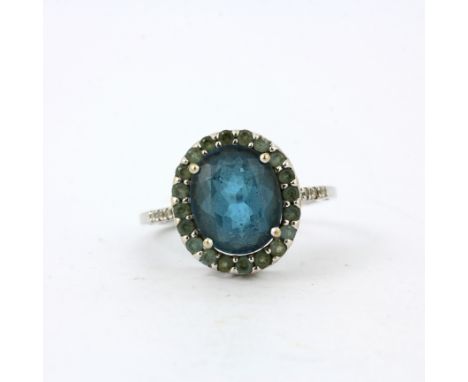 A 14ct white gold (marked 14K) ring set with a large oval cut blue tourmaline and green stones, (N.5).