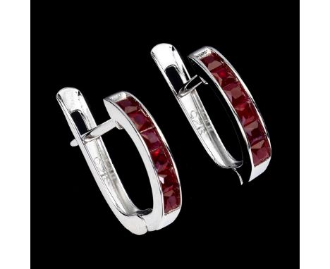 A pair of  925 silver earrings set with step cut rubies, L. 1.3cm.