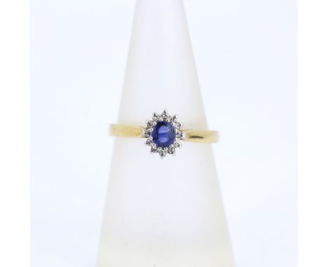 A 9ct yellow and white gold sapphire and diamond set cluser ring, M.5.