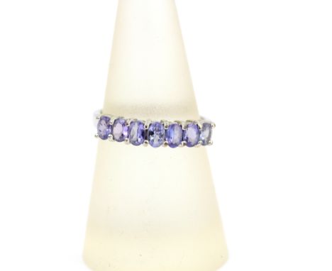 A 9ct white gold oval cut tanzanite set half eternity ring, N.5.