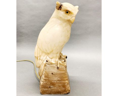 A large early 20th C carved alabaster owl light with glass eyes, A/F to one ear, H. 44cm.