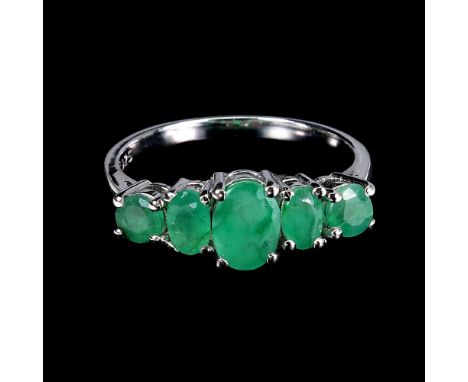 A 925 silver ring set with graduated oval cut emeralds, ring size O.
