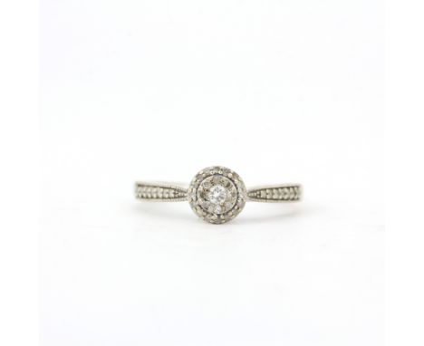 A 9ct white gold diamond set cluster ring with diamond set shoulders, (P).