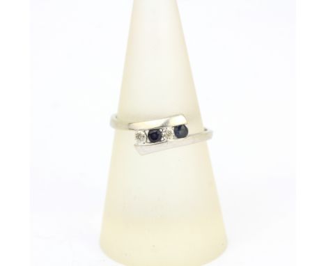 A 9ct white gold sapphire and diamond set crossover ring, (O.5).
