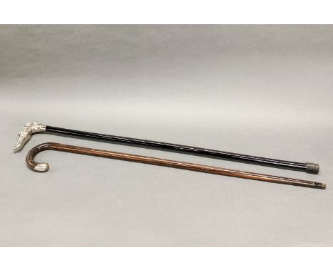 A hallmarked silver mounted walking stick together with a dog handled walking stick.