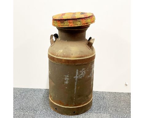 An antique milk churn upholstered with removable lid as a stool, H. 66cm.