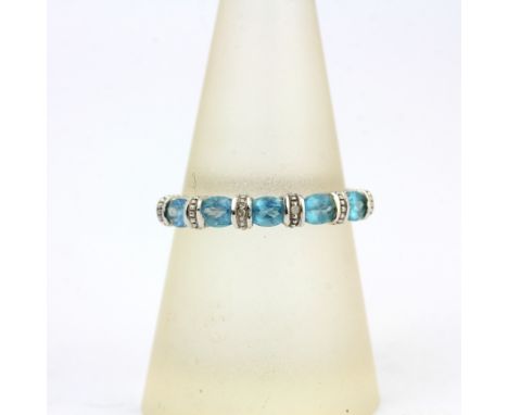 A 9ct white gold blue topaz and diamond set ring, (P).
