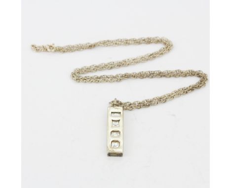 A hallmarked silver ingot pendant and chain, L. 54cm.