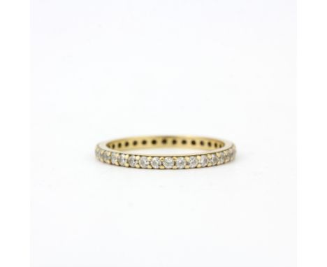 A 14ct gold white stone set full eternity ring, (M.5).