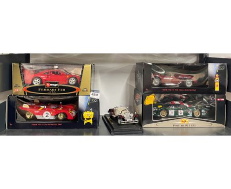 Four large boxed diecast model vehicles and one unboxed.